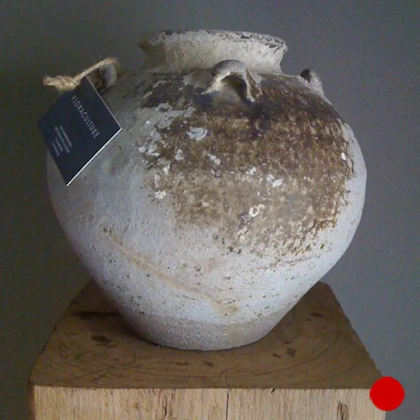 Antique glazed storage jar on a wooden plinth