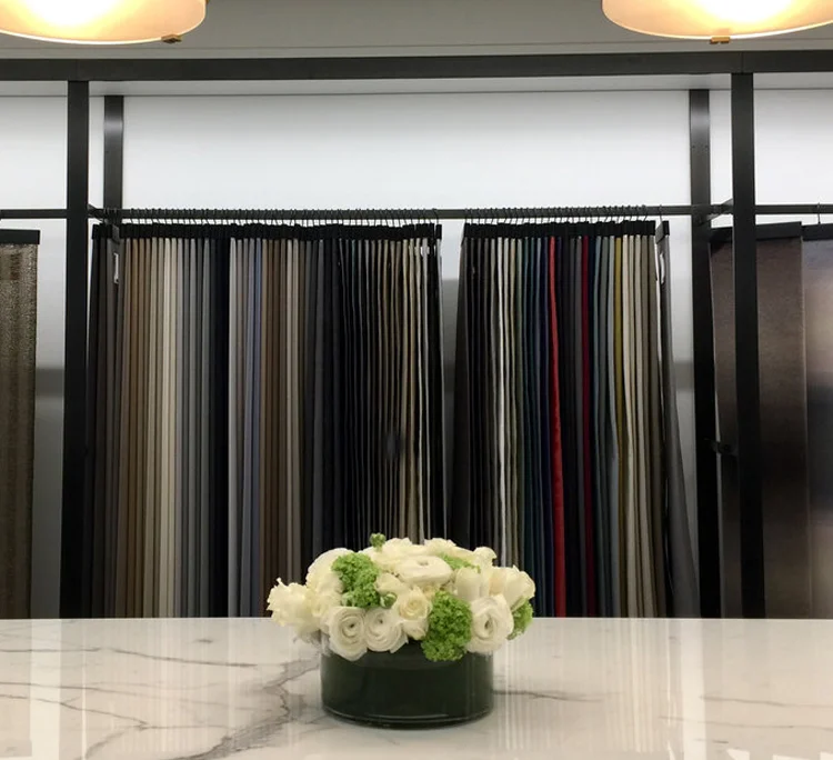 White ranunculus on marble before textiles