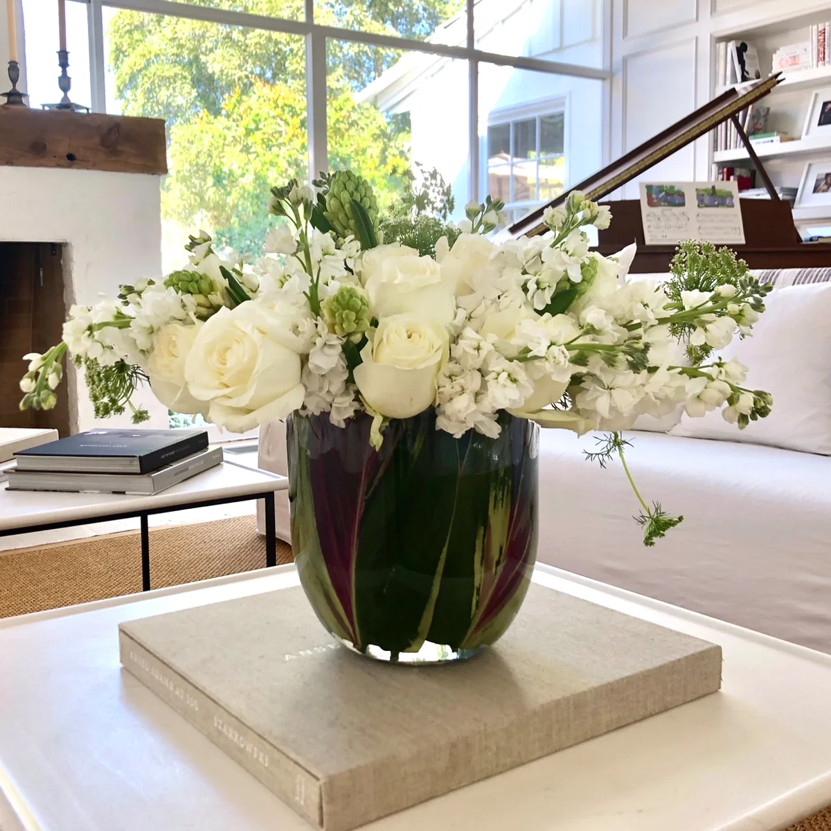 White florals styled in a sunlit living room